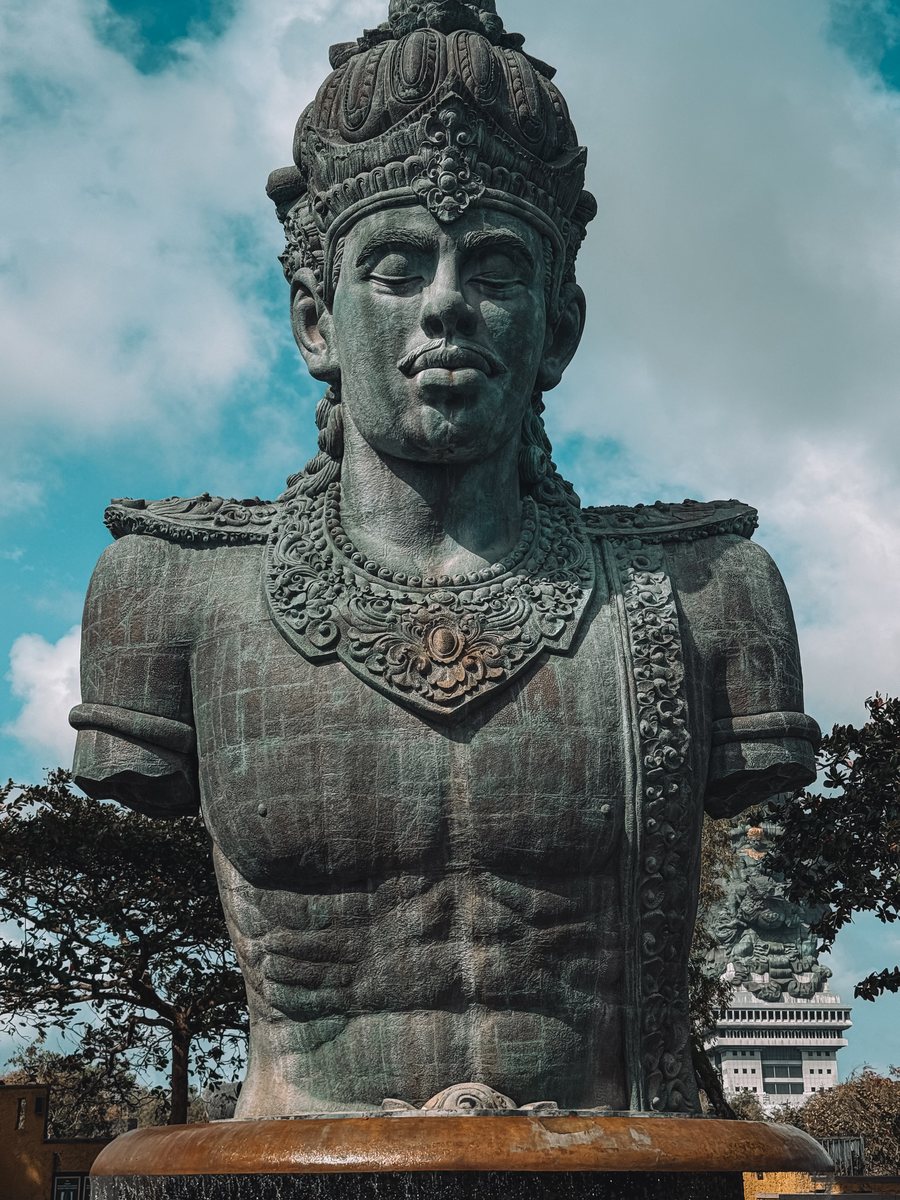 Le buste de la statue de Garuda Wisnu Kencana vu de près, sous un ciel nuageux